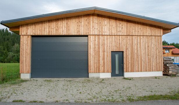 New modern rolling garage doors. Automatic gray roller shutter entrance door of an industrial warehouse.
