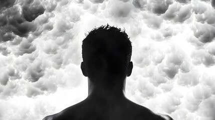 Silhouette of a Man Against Dramatic Clouds in Black and White