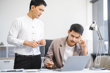 Two businessmen argue in the modern workplace after making a mistake. They discuss poor performance, analyze the issue, and seek solutions to improve efficiency and prevent future errors