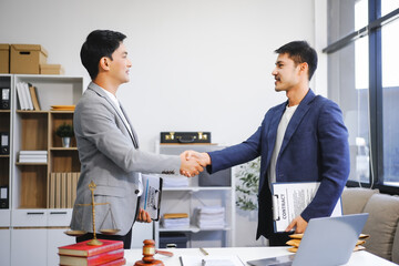 A businessman and a male lawyer or a team of judges discuss a joint investment meeting. They...