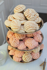 Three-layer display of traditional Mexican pastries.