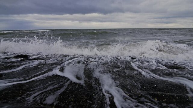Waves crashing on rocks at the beach in Domburg, Netherlands in super slow motion