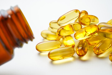 Vitamin capsules in a bottle, soft gels, Fish oil capsules, omega 3, omega 9, vitamin D, vitamin E