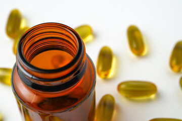 Vitamin capsules in a bottle, soft gels, Fish oil capsules, omega 3, omega 9, vitamin D, vitamin E