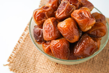 Dates fruit sukari or kurma sukari, in bowl isolated on white background
