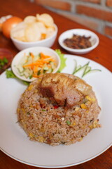fried goat rice. cooked with lots of spices and goat meat. suitable to be served while hot or when it's raining. indonesian food on the table.