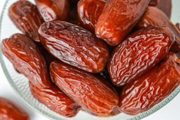 Dates fruit tunisia, Tunisian honey dates, in bowl isolated on white background