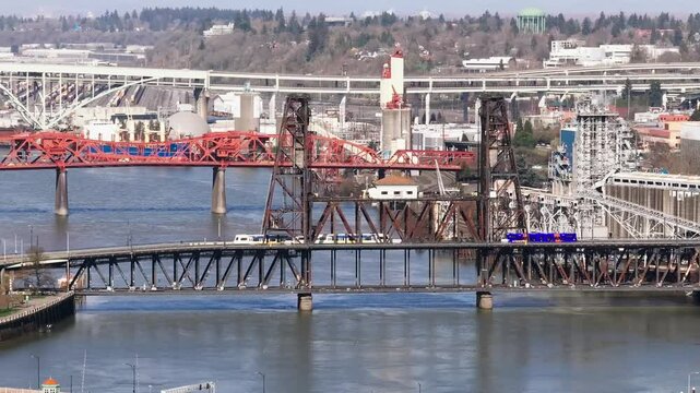 Commuter Train Light Rail Crossing the Steele Bridge and WIllamette River in Sunny Downtown Portland Oregon