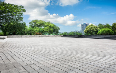 Expansive Urban Park with Lush Greenery and Clear Blue Sky