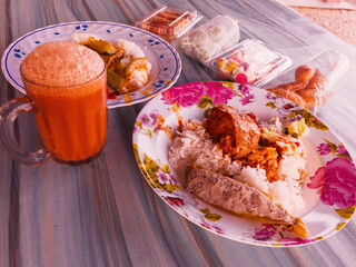 Traditional Malaysian breakfast food, Nasi berlauk with kuih snacks served with teh tarik.