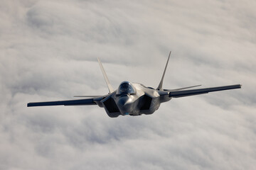 Very  close frontal view of a F-35C Lightning II   over clouds