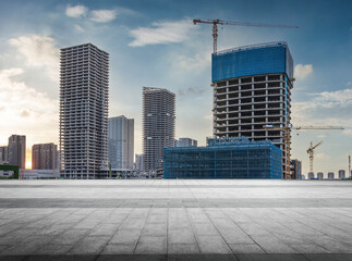 Modern Urban Development at Sunset with Construction Cranes