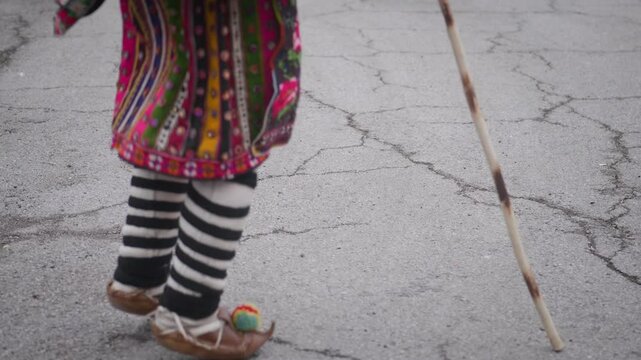 Traditional folklore shoes with pom-poms worn by jumping Balkan dancer