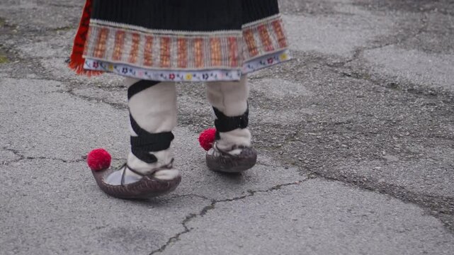 Traditional folklore footwear with pom-poms worn by Balkan dancer