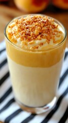 Garnished peach smoothie, soft and creamy, topped with coconut flakes