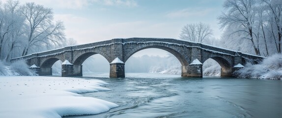 Snow covered stone bridge over a shimmering winter river.