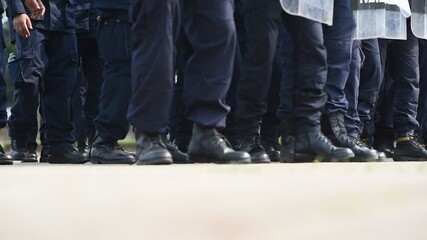 Riot police control the crowd..