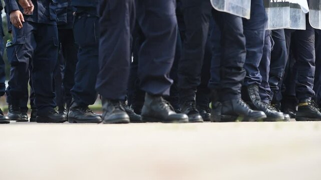 Riot police control the crowd..