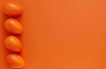 Easter, colorful eggs arranged on the left, on a bright orange background, suitable for festive designs and decorations.