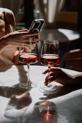 Glasses of rose wine seen during a friendly party or a celebration in a restaurant of a bar.