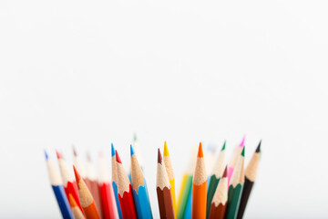 Sharp wood color pencils in a cup, composed with copy space.