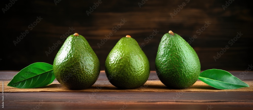 Poster three ripe avocados in shades of green arranged in a row on a wooden background with vibrant green l
