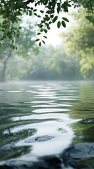 Naklejka premium A serene water scene surrounded by lush greenery and soft mist.