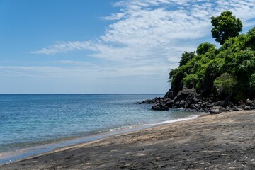 Serene beach with lush green cliffs