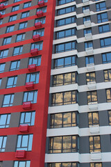 Windows of Smart Flats On Multi Colored High Rising Apartment House. Modern Architecture of Multi Storey Block of Flats
