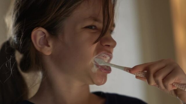 The girl brushes her teeth for the purpose of recovery, oral hygiene. The child takes care of dental health.