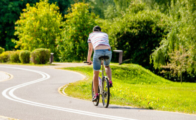 Naklejka premium Cyclist ride on the bike path in the city Park 