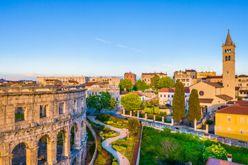 A breathtaking aerial view of Pula Arena in Croatia, showcasing the well-preserved Roman amphitheater surrounded by the historic city center, featuring the charm of this coastal Adriatic town