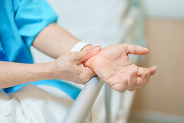 Elderly Patient Woman having wrist pain in hospital, muscle ache due to Carpal Tunnel Syndrome, De...