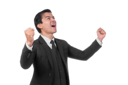Excited and joyful young businessman wearing a formal black suit and tie, raising his fists in celebration of success achievement, showing happiness and triumph, isolated on a transparent background