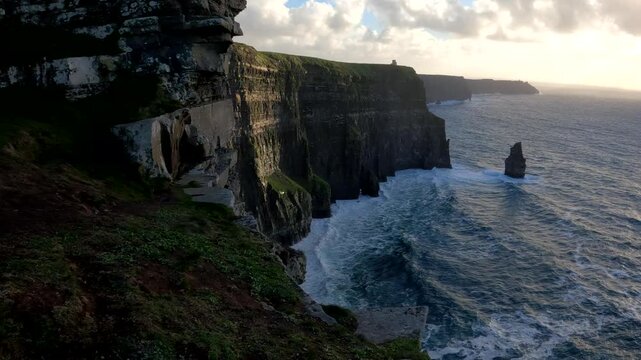 Atlantic Ocean waves below ugged beauty of the Cliffs of Moher, Ireland