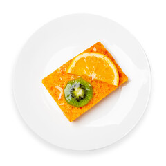 Carrot cake with orange and kiwi on a plate on a white background, top view, isolant.