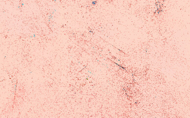 Soft pastel background with scattered dots and subtle scratches, creating an abstract textured effect.