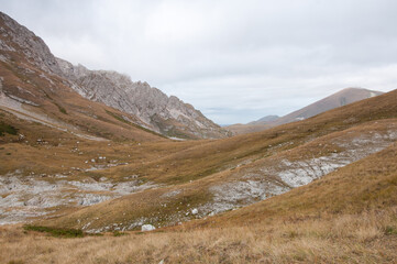 Picturesque autumn view of the mountain range in the Republic of Adygea with its rocky grass-covered slopes, Russia