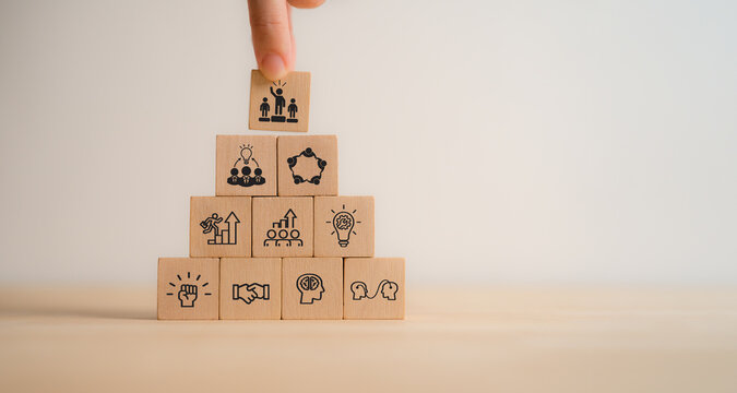 Agile leadership concept. Wooden blocks with core principles of agile leadership icons representing trust, collaboration, empowerment, adaptability, leadership. Professional agile leadership.