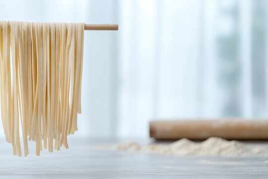 Freshly made pasta hangs elegantly, showcasing its delicate stra