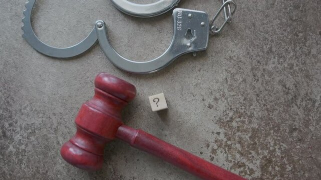 judge hammer and handcuffs question mark