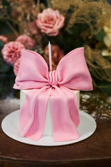 A cake for a girl with a pink bow. Child's birthday