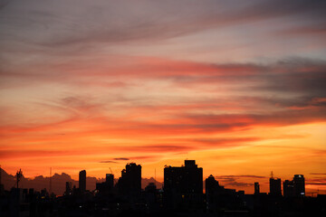 The sky is orange and the sun is setting