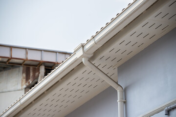 A white roof with a white gutter and a white pipe