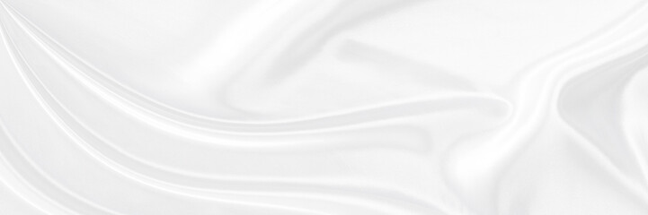 White gray satin texture that is white silver fabric silk panorama background with beautiful soft blur pattern natural.