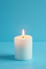 Serene sky blue backdrop, single white wax candle's gentle flame , peace, reflection, small