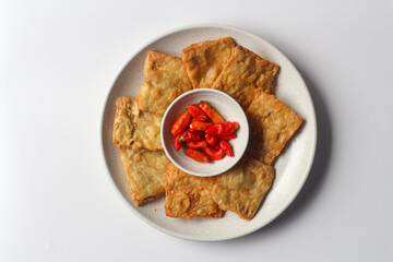 Fried tempeh served with red chili peppers, one of popular street food from Indonesia.
