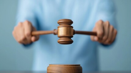 Wooden Gavel in Hand   Symbol of Justice Legal Authority and Judicial Decision Making in Courtroom Trials and Litigation Processes
