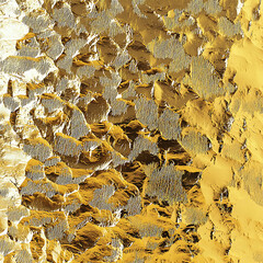 Shiny textured gold foil with metallic hammered surface