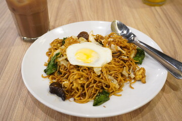 Sweet fried noodles with fried egg and healthy vegetables